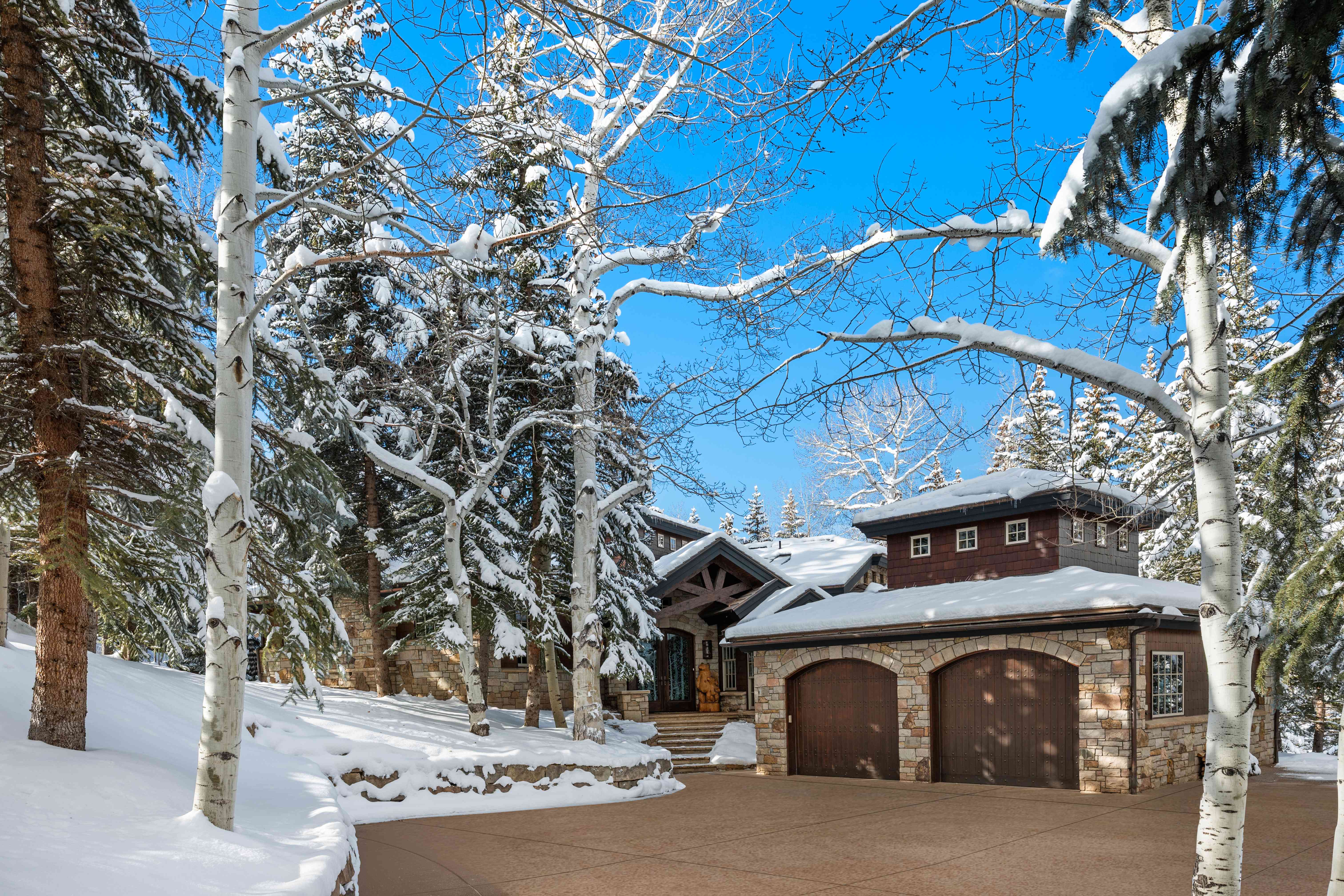 81 Spruce Ridge Lane - Winter view of luxury mountain home with snow-covered aspens